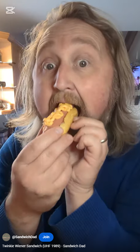 Sandwich Dad taking a big bite of a Twinkie Wiener Sandwich
